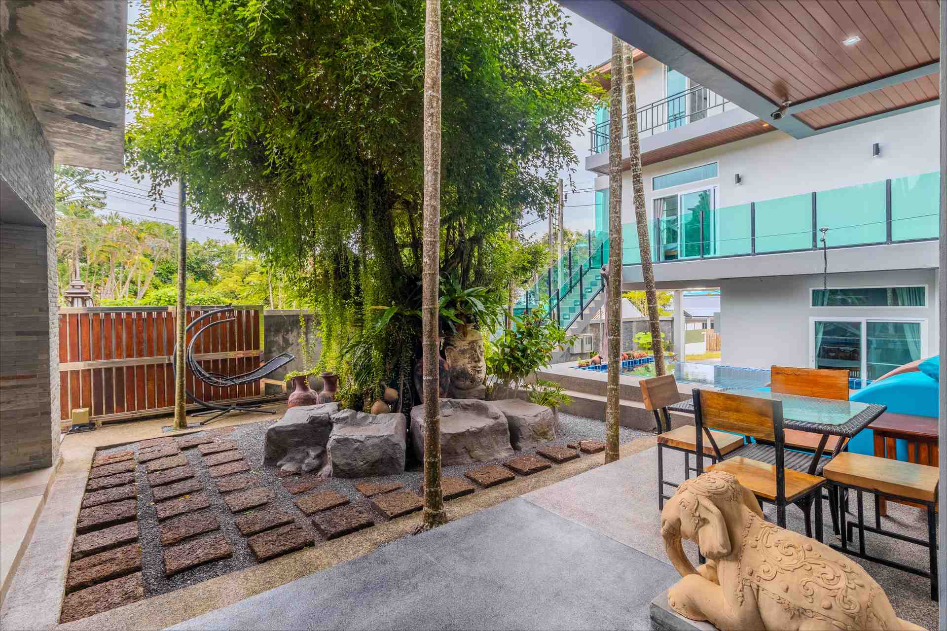 Panoramic view of the manicured estate grounds showcasing the scale of the tropical landscaping