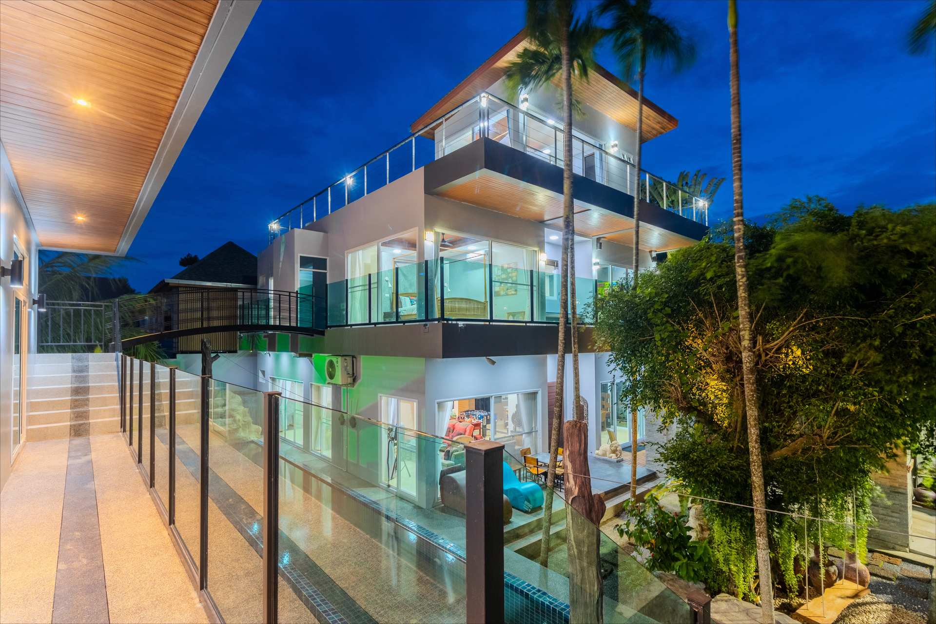 Modern tropical facade of Rawai Estate Villa showcasing contemporary Thai architecture with clean lines and natural materials